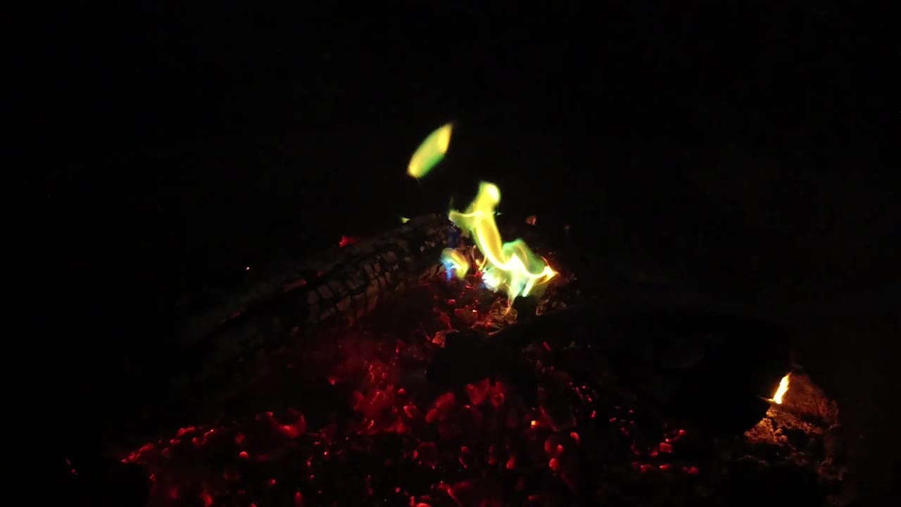 Bright flame and red coals in black interior