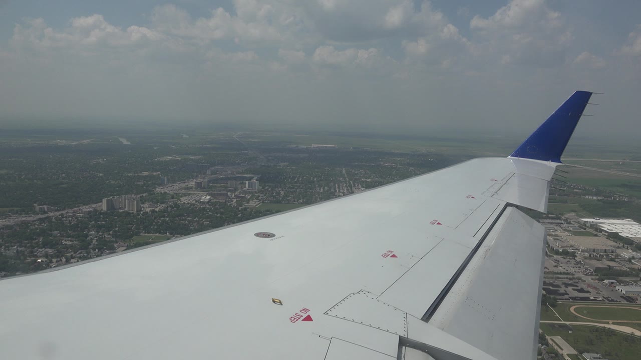 Aircraft wing with city below