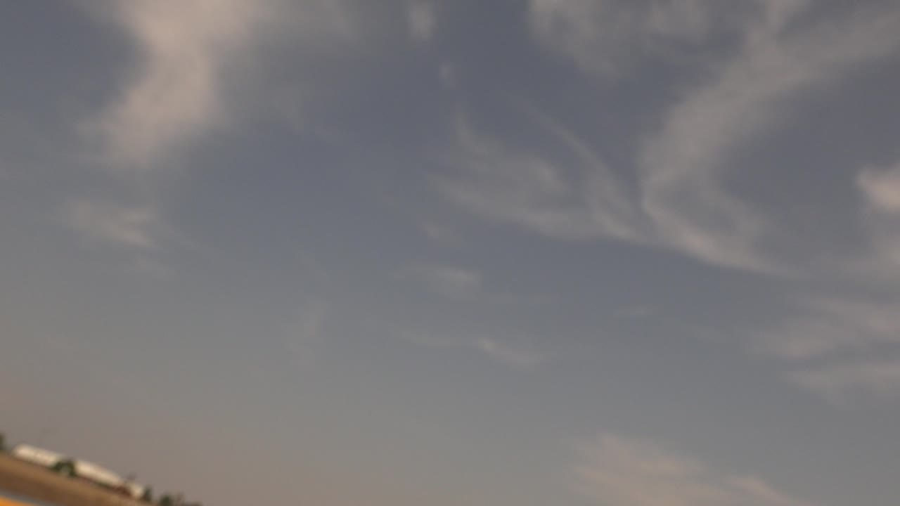 Blurred sky over a slanted lake shoreline.
