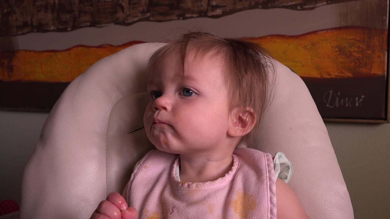 A close view shows the baby in Hidden Lake, Colorado still looking to the side, with one small hand partly visible at the lower edge.