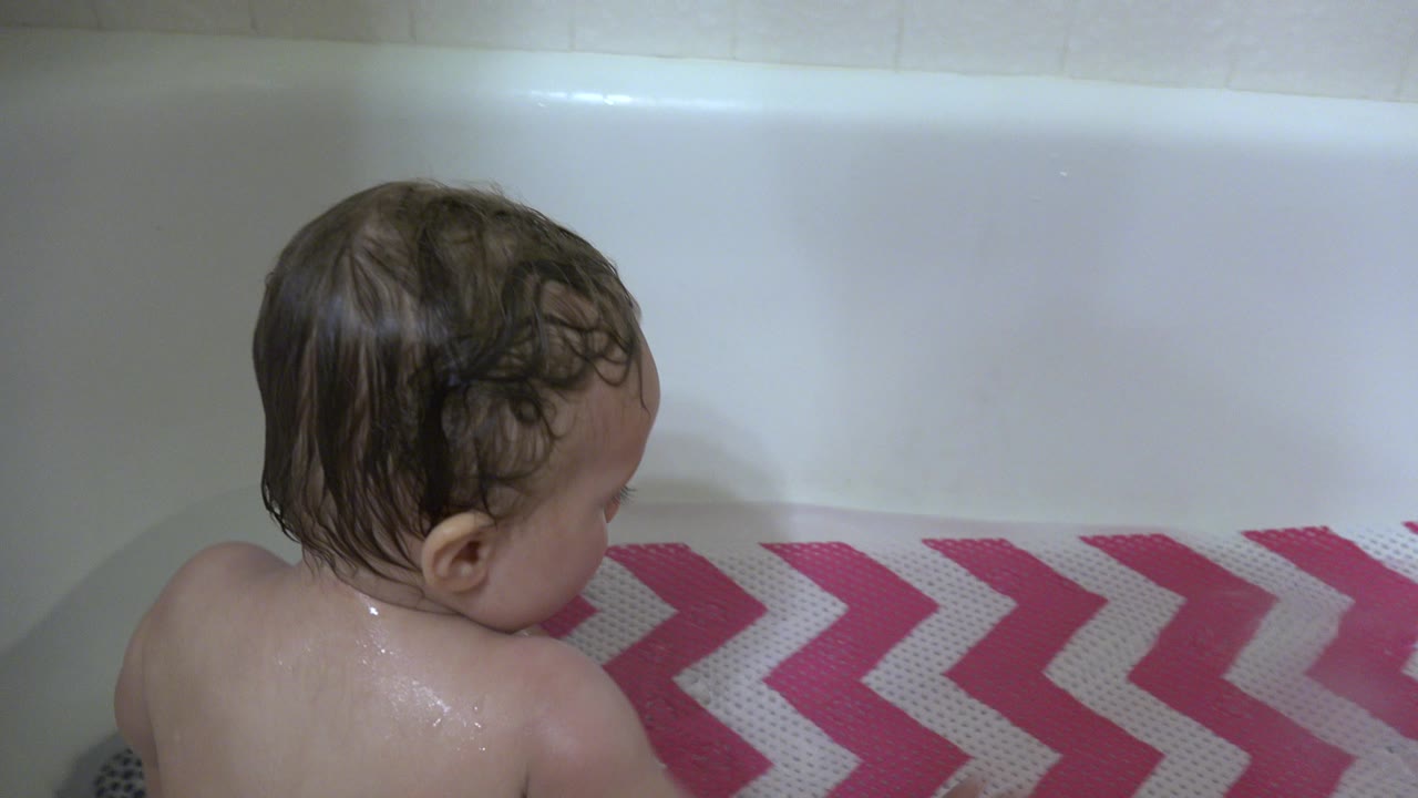 At 0:01 in Westminster, Colorado, the toddler faces toward the right side of the tub while the chevron bath mat fills the lower frame.