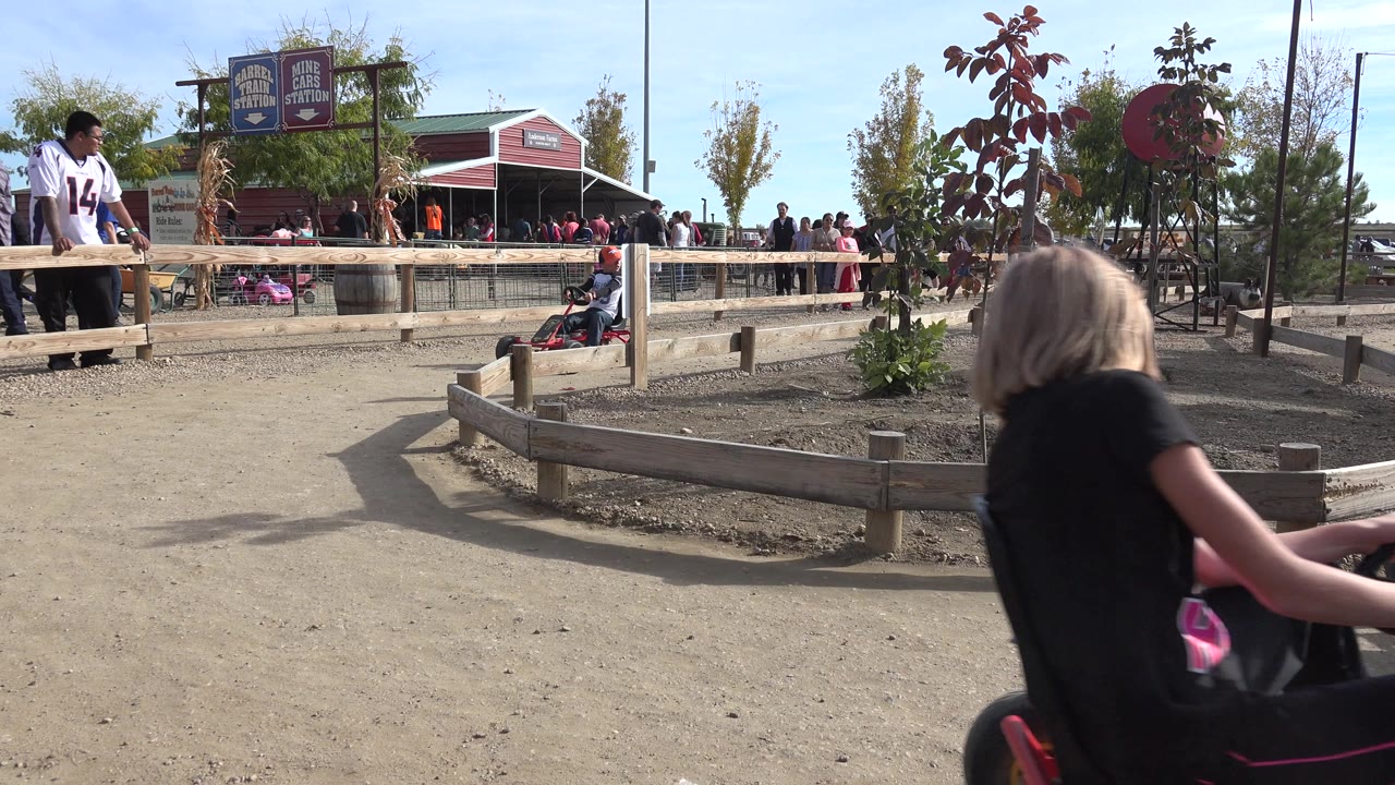 Blond child in a pedal go-kart entering from the right edge.
