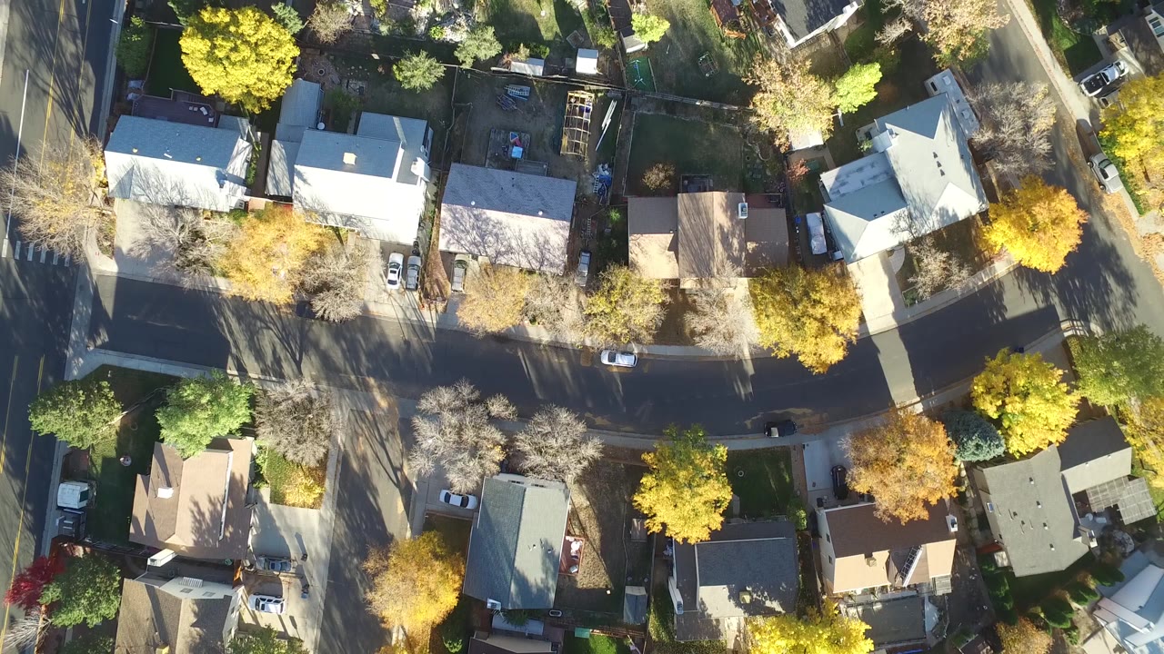 Aerial view of residential streets and tree-lined houses.