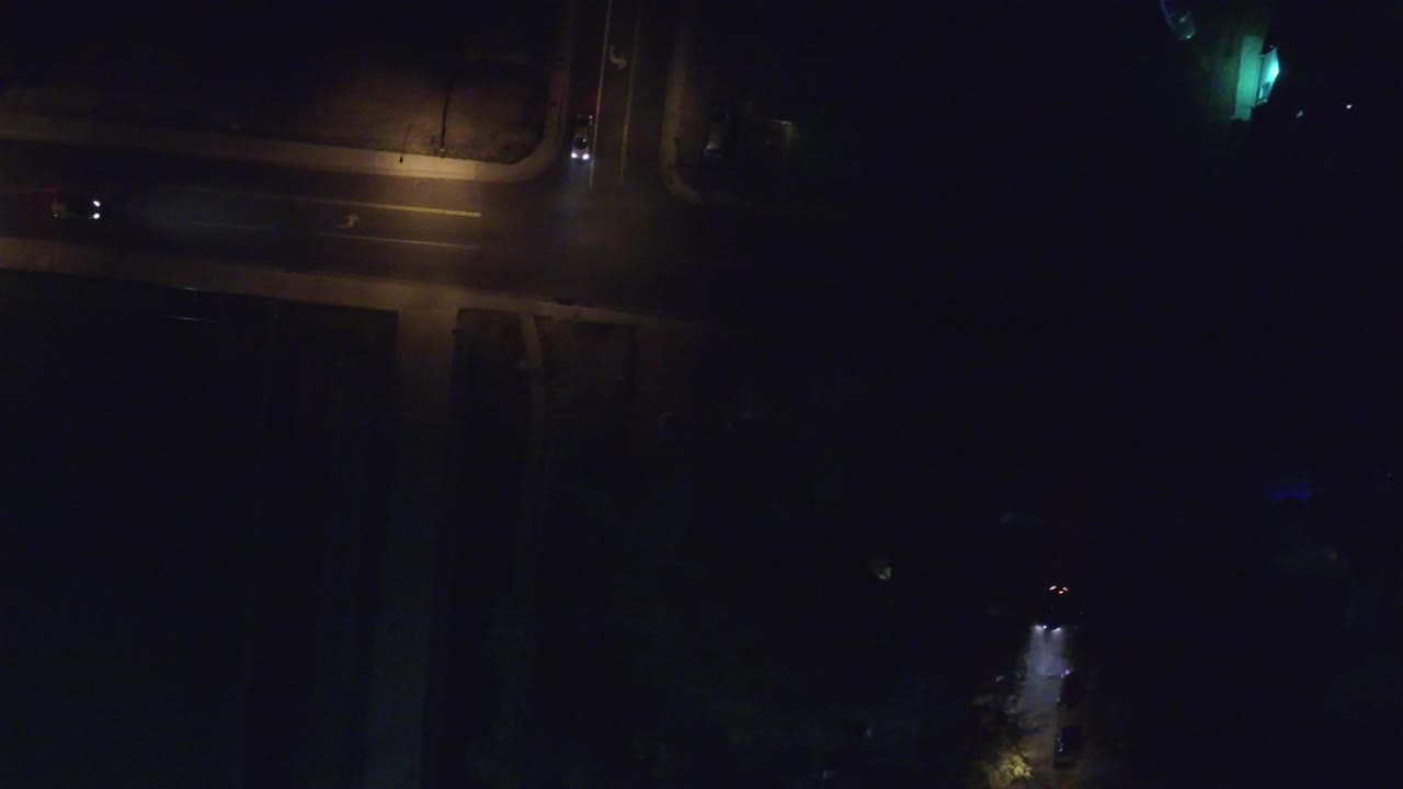 Aerial nighttime frame in Hidden Lake, Colorado, showing the lit road junction shifting slightly across the top of the image, with no visible people.