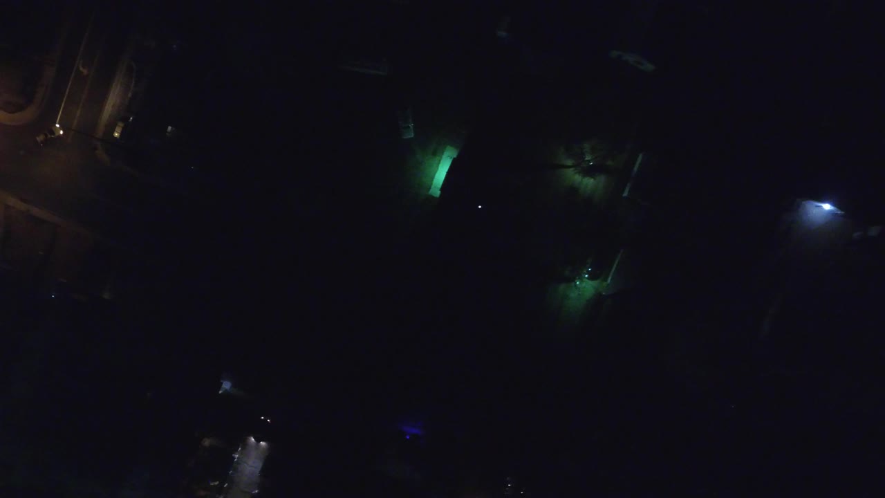 Dark overhead night frame from Hidden Lake, Colorado with small green and white light sources scattered across a mostly black view, no visible people.