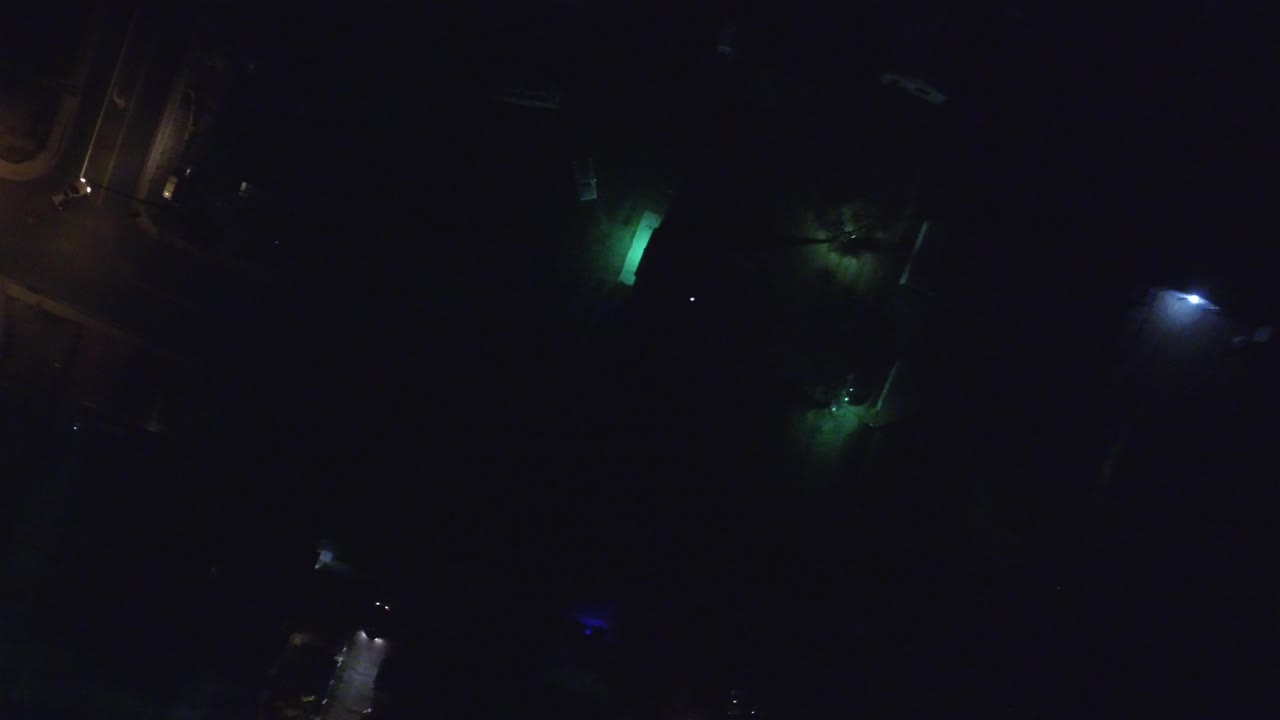 Second Hidden Lake, Colorado night frame with a bright green patch near the upper center, dim white light at right, and no visible people.