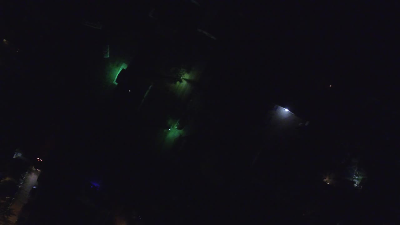 A later overhead frame shows Hidden Lake, Colorado at night with isolated green, blue, amber, and white lights against deep darkness and no visible people.