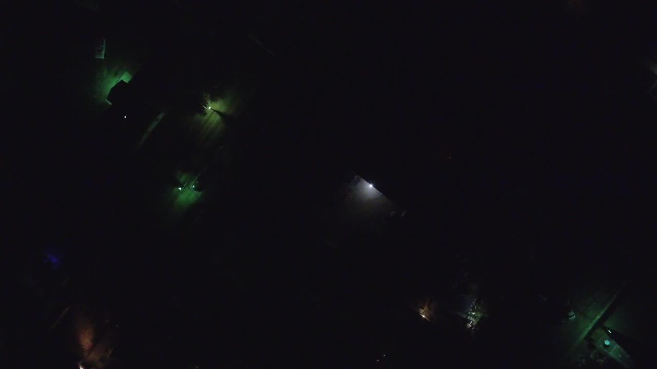 Scattered colored lights on a nearly black background.