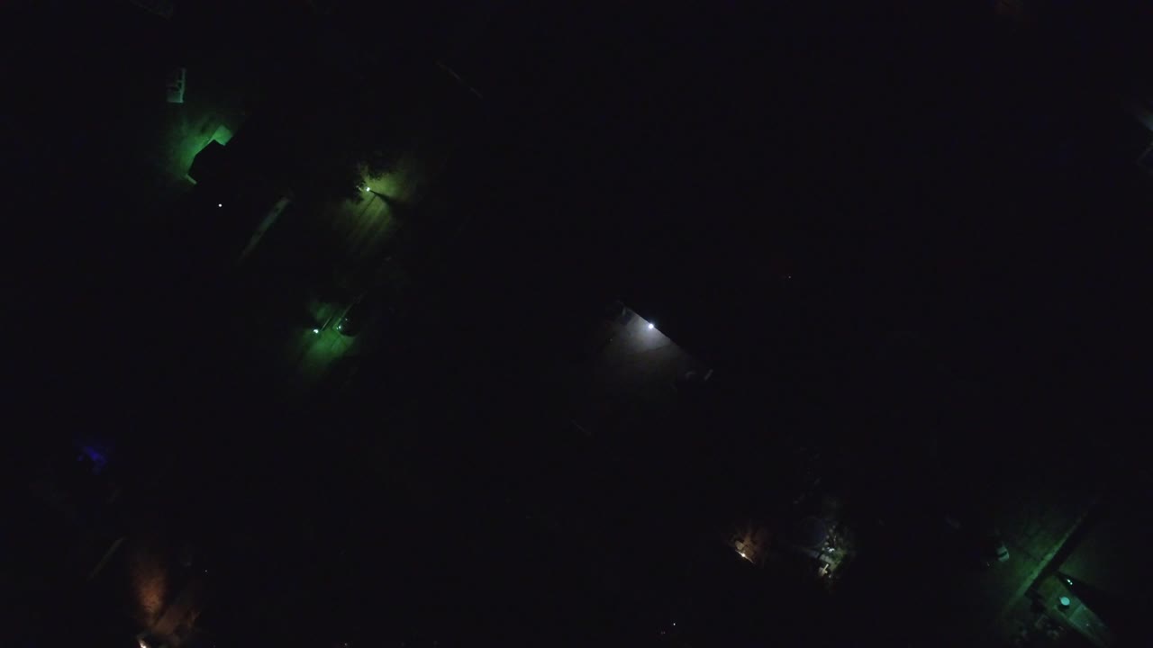 At 0:01, the Hidden Lake, Colorado frame keeps the lights widely spaced, with green glows near the upper and lower areas and a small white light to the right, with no visible people.