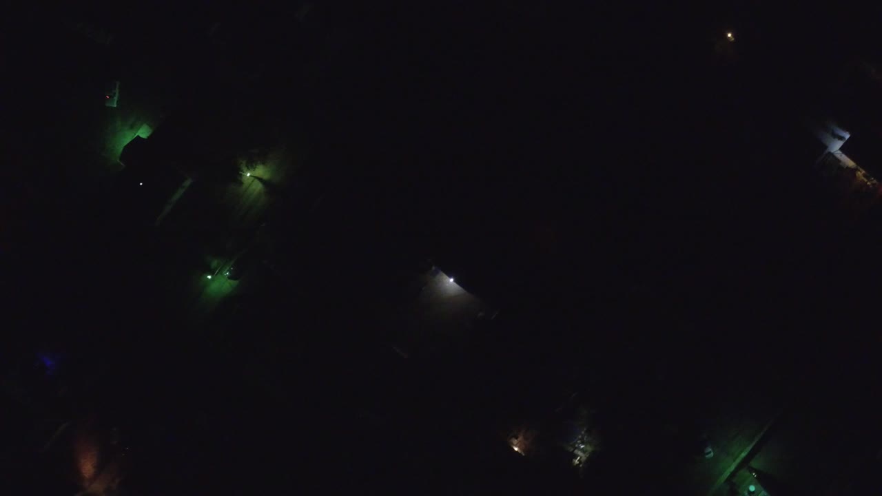 Very dark overhead view of Hidden Lake, Colorado at night, with small green and white lights punctuating a mostly black residential frame and no visible people.