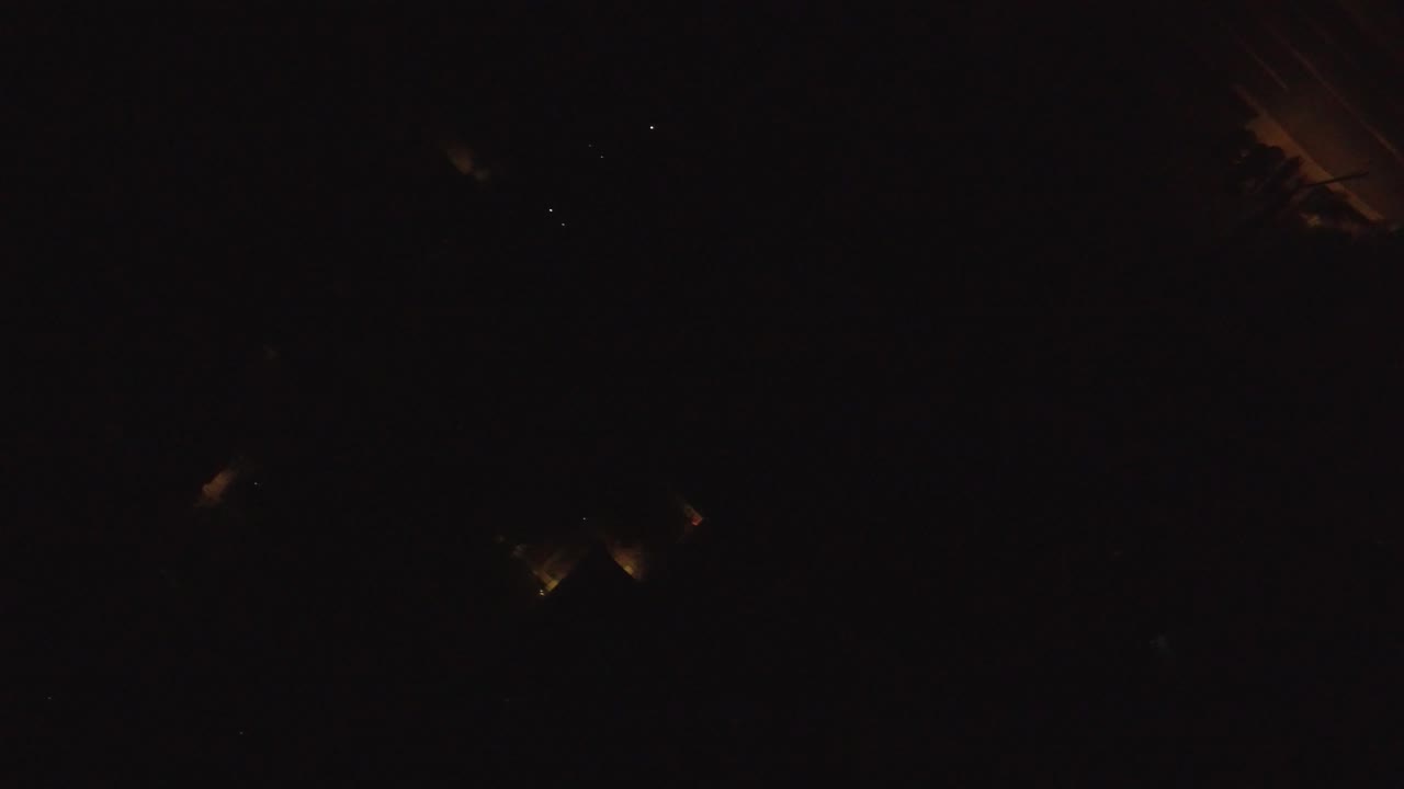 Very dark aerial view from Hidden Lake, Colorado, with a faint warm orange streak near the upper right and no visible people.