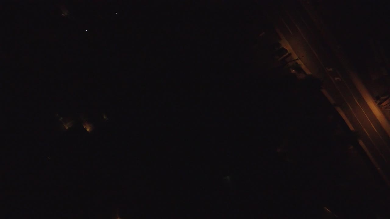 At 0:01, the Hidden Lake night frame keeps the diagonal roadway near the right side while most of the image remains black, with no visible people.