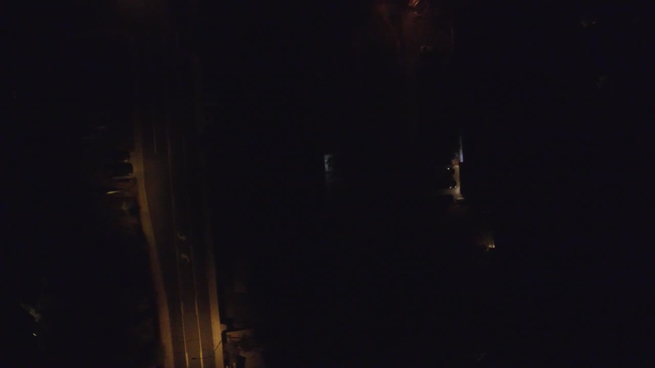 A dark Hidden Lake Colorado view shows the amber-lit vertical area shifted slightly within the frame, with sparse pinpoints of light and no visible people.