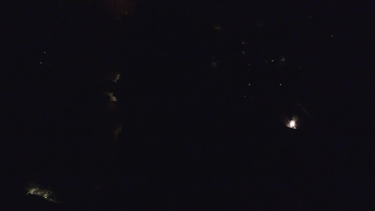 Nearly black night scene with a few tiny distant lights