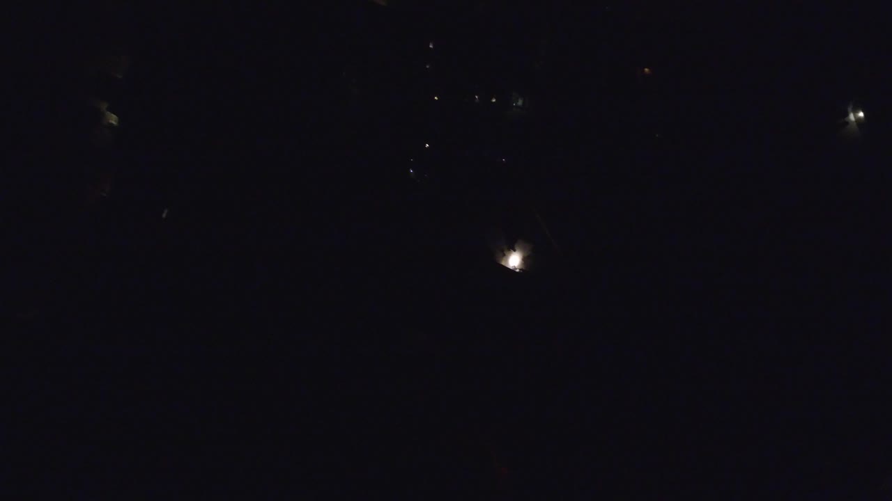 At 0:01, the Hidden Lake Colorado view remains very dark, with one brighter star-like point lower in the frame and dim scattered specks above, with no visible people.