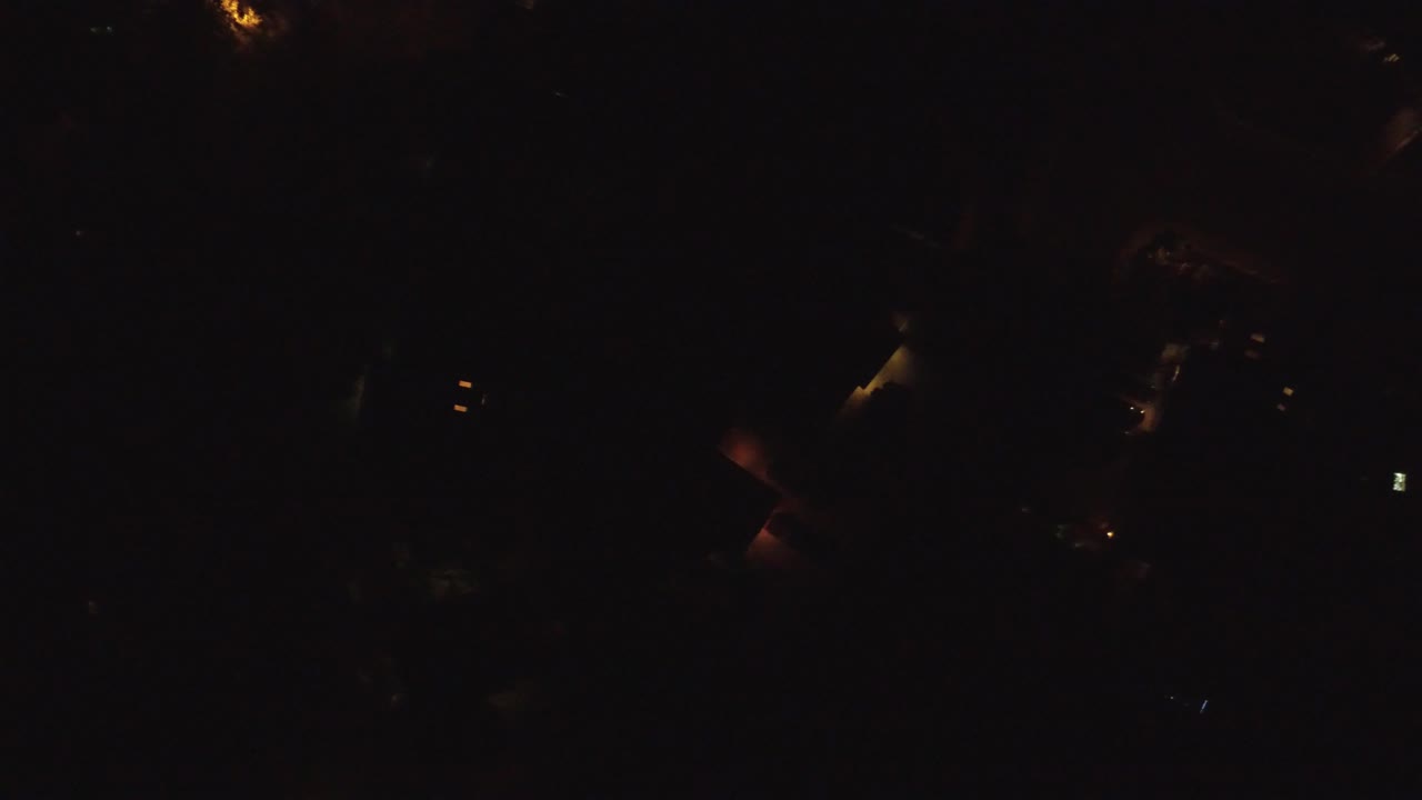 A very dark Hidden Lake, Colorado night frame with a few warm residential lights and no visible people.