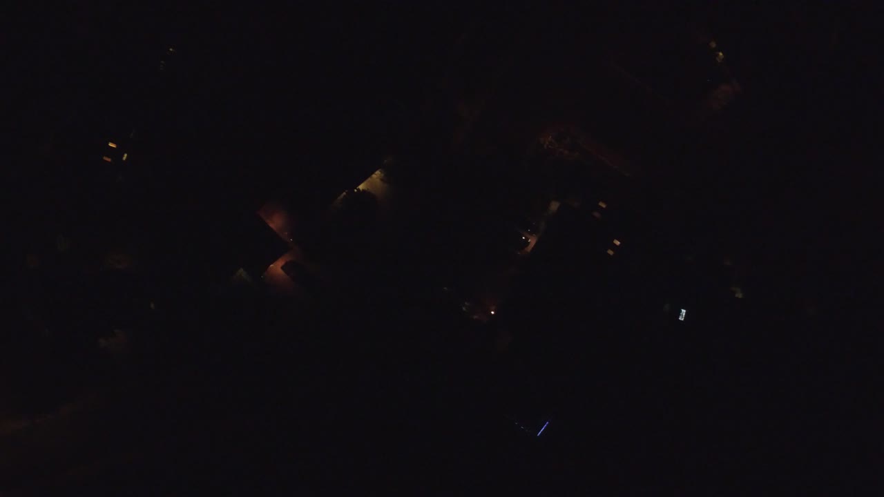 At 0:01, the Hidden Lake, Colorado frame remains very dark, with a small cluster of warm lights near the upper area and no visible people.