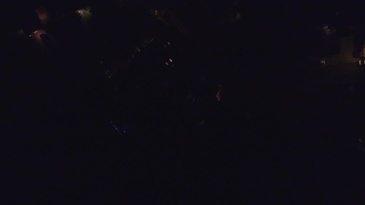 Hidden Lake, Colorado nighttime frame with faint roof shapes, small amber lights, deep shadows, and no visible people.