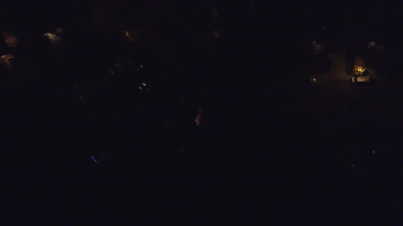 Opening frame of the Hidden Lake, Colorado night scene with scattered dim lights in deep darkness and no visible people.