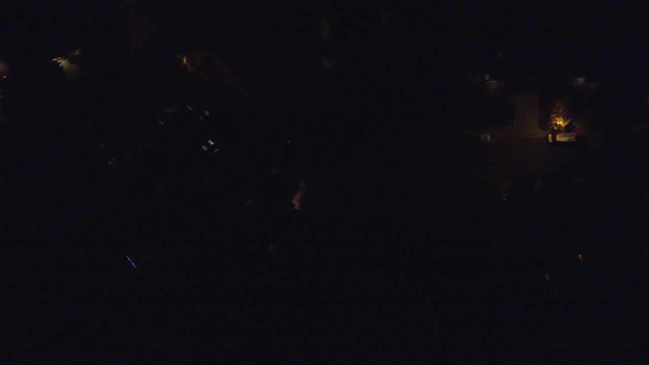 Mostly black frame with dim lights at the edge of the scene.