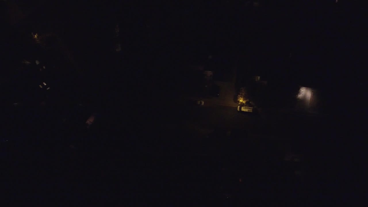 Very dark overhead neighborhood with clustered street lighting