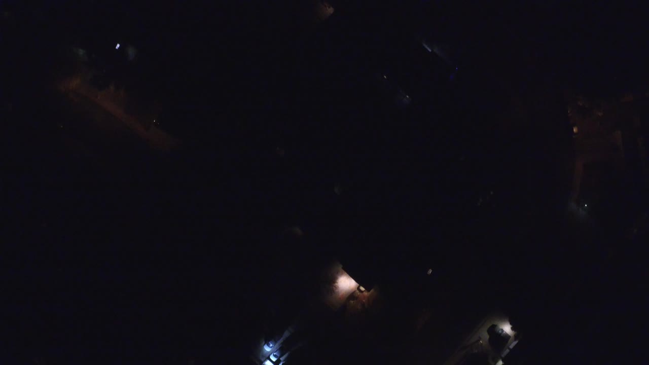 Low-light overhead view in Hidden Lake, Colorado with small bright spots separated by large areas of darkness and no visible people.