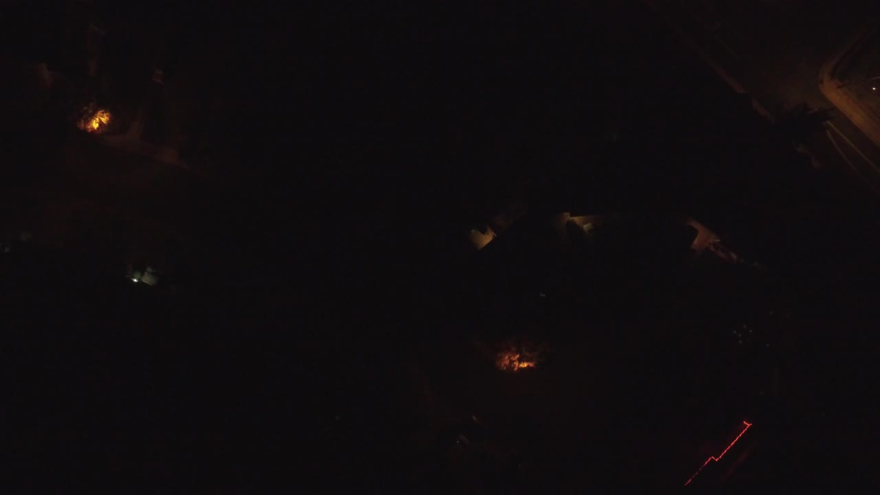 Dark overhead frame with scattered lights and a faint red line