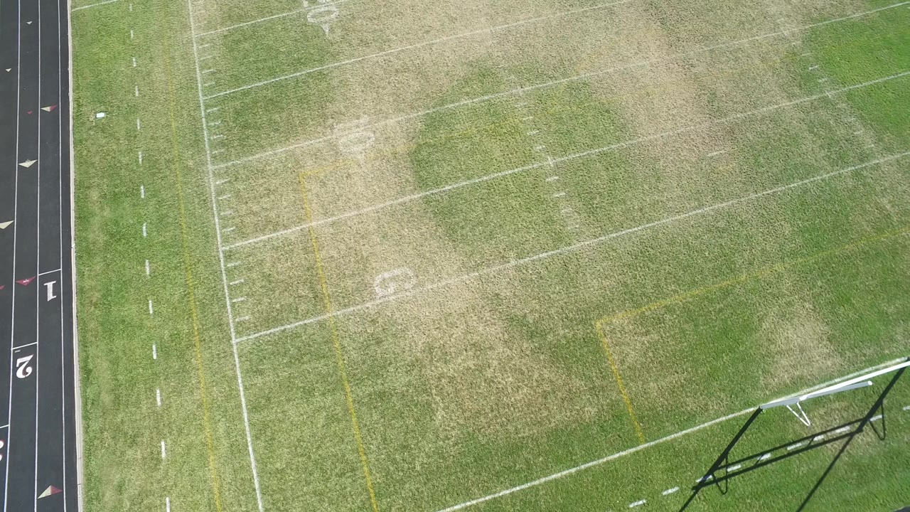 Football field turf and yard lines seen from above.