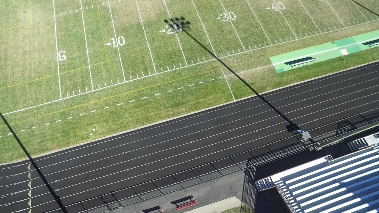 Football field markings and running track seen from a drone angle.