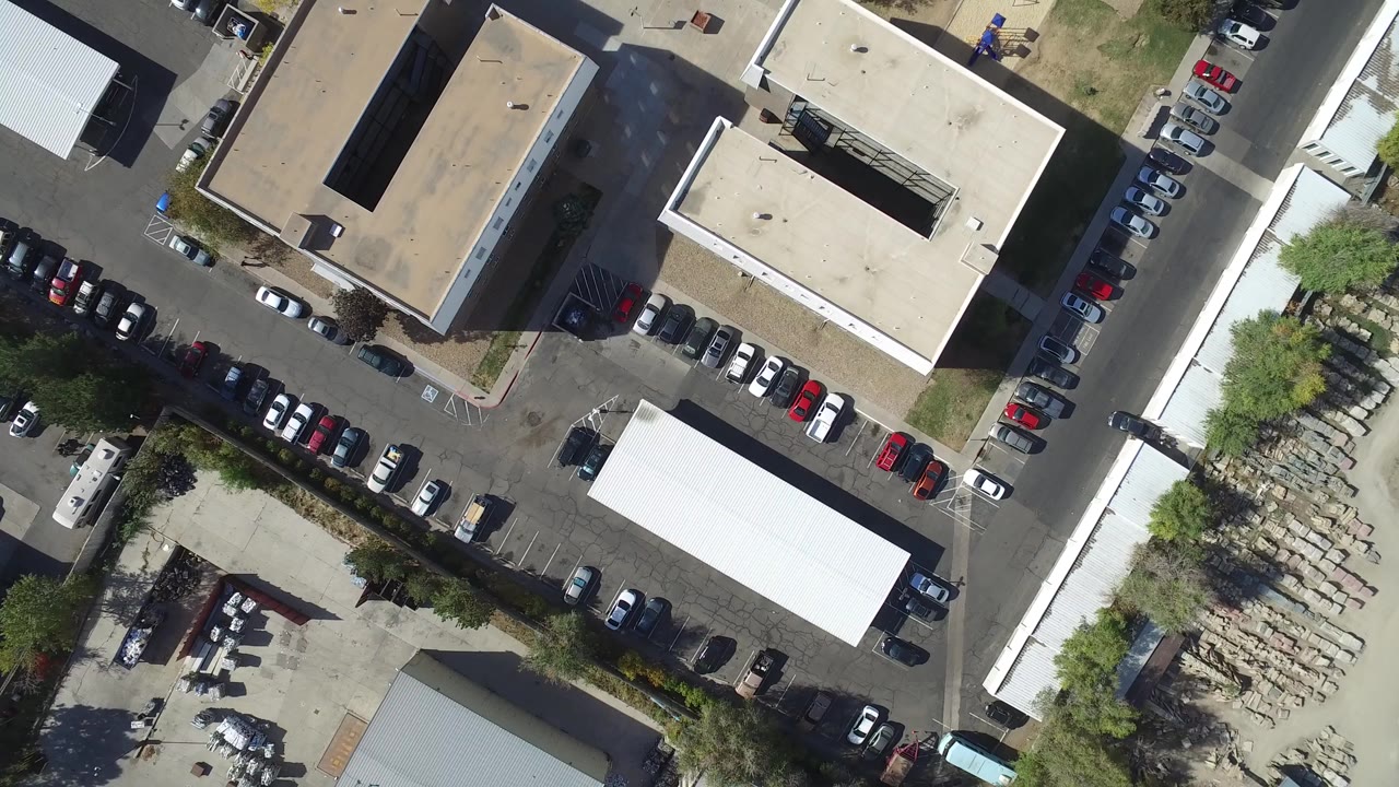 Top-down aerial view of office buildings and parking lots.