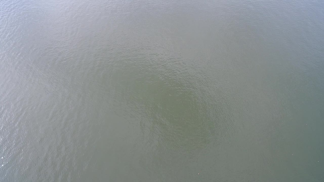 Open water seen from above with soft blue and gray ripples.