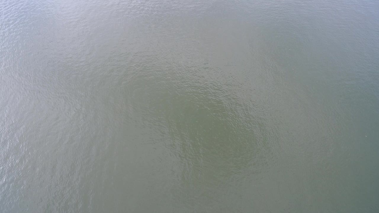 Pale green lake water with soft ripples filling the frame.