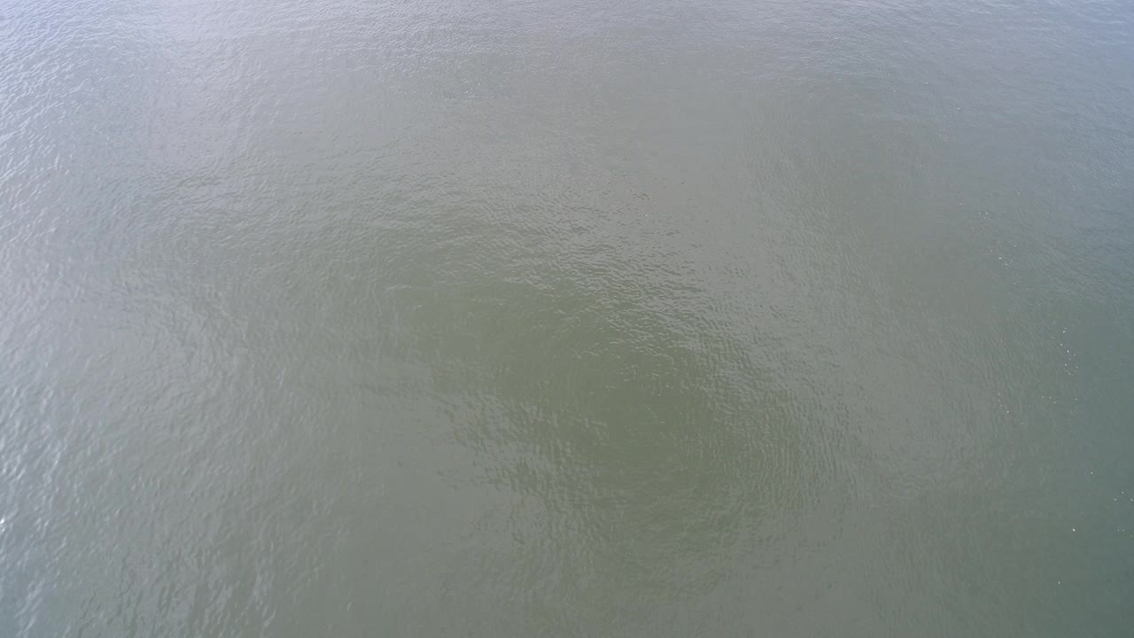 Overhead view of green-gray water at Hidden Lake, Colorado, with fine ripples and no visible people.