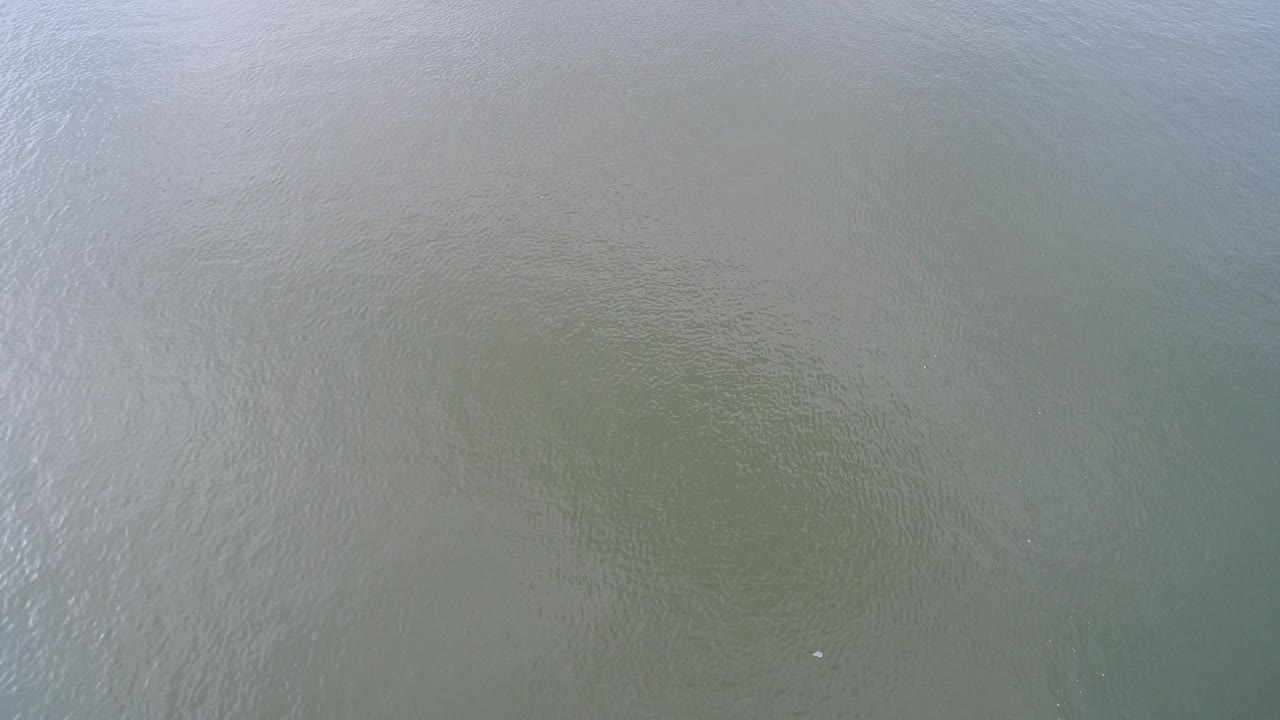 Shallow Hidden Lake water fills the frame, with a light ripple band crossing the surface and no visible people or structures.