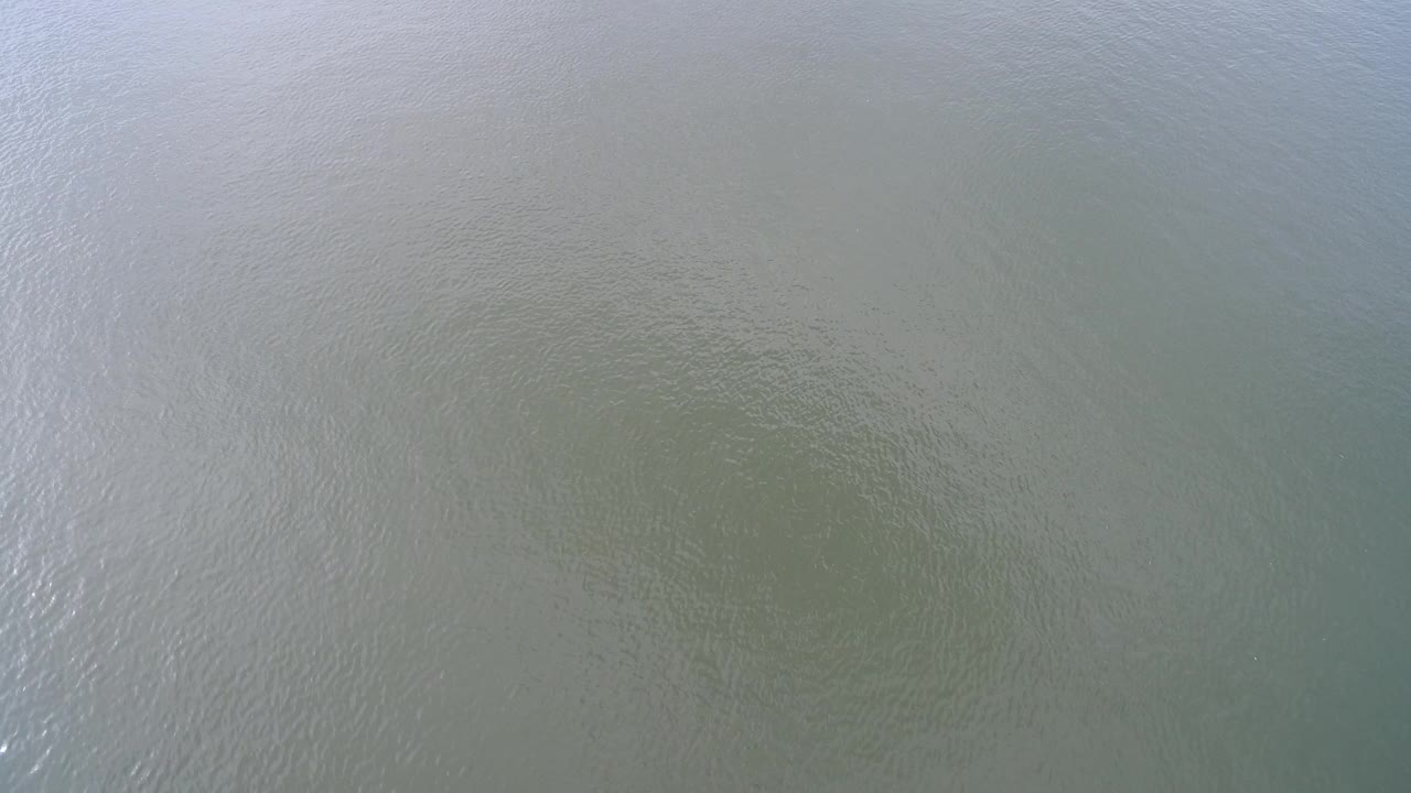 At 0:01, the Hidden Lake, Colorado surface shows faint darker green patches under rippled water, with no visible people.