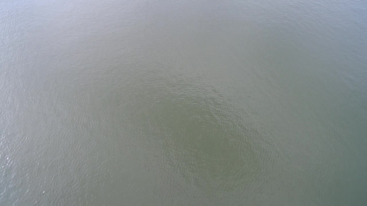 Lake water surface with brighter reflective streaks