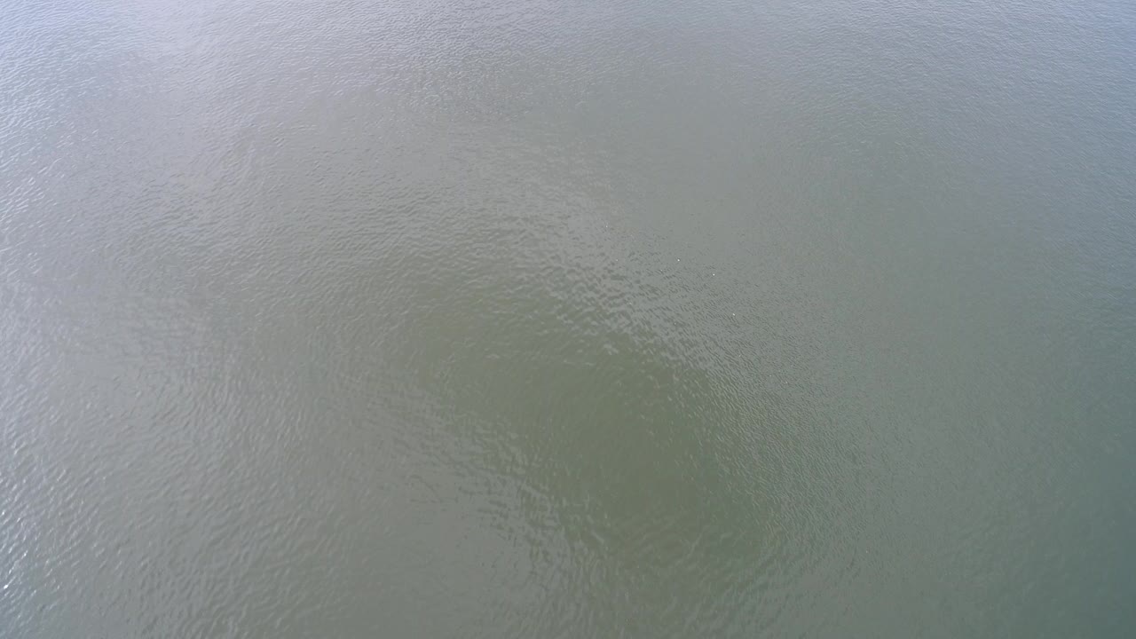 Green-blue lake water with faint ripples