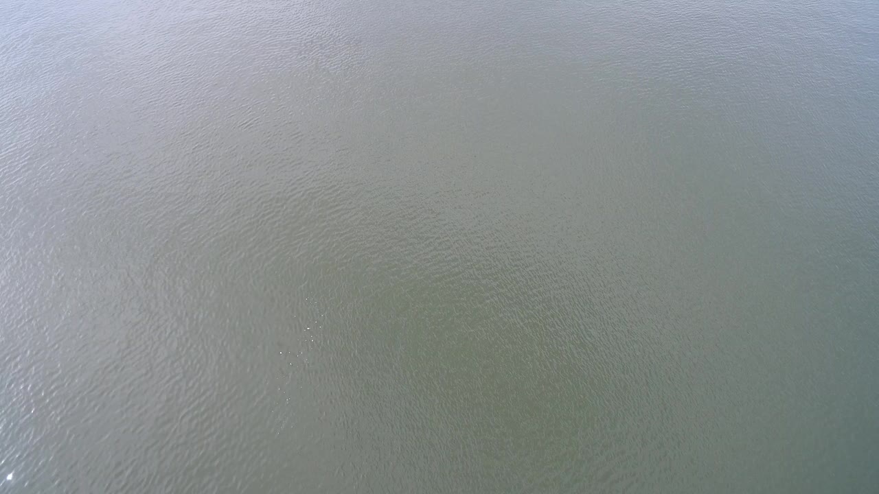 Overhead view of rippled green-blue lake water.