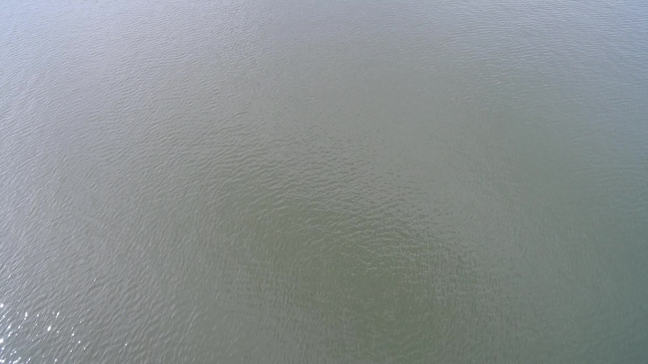 Hidden Lake water fills the frame with fine ripples, soft gray-blue reflection near the upper area, and no visible people or shoreline.