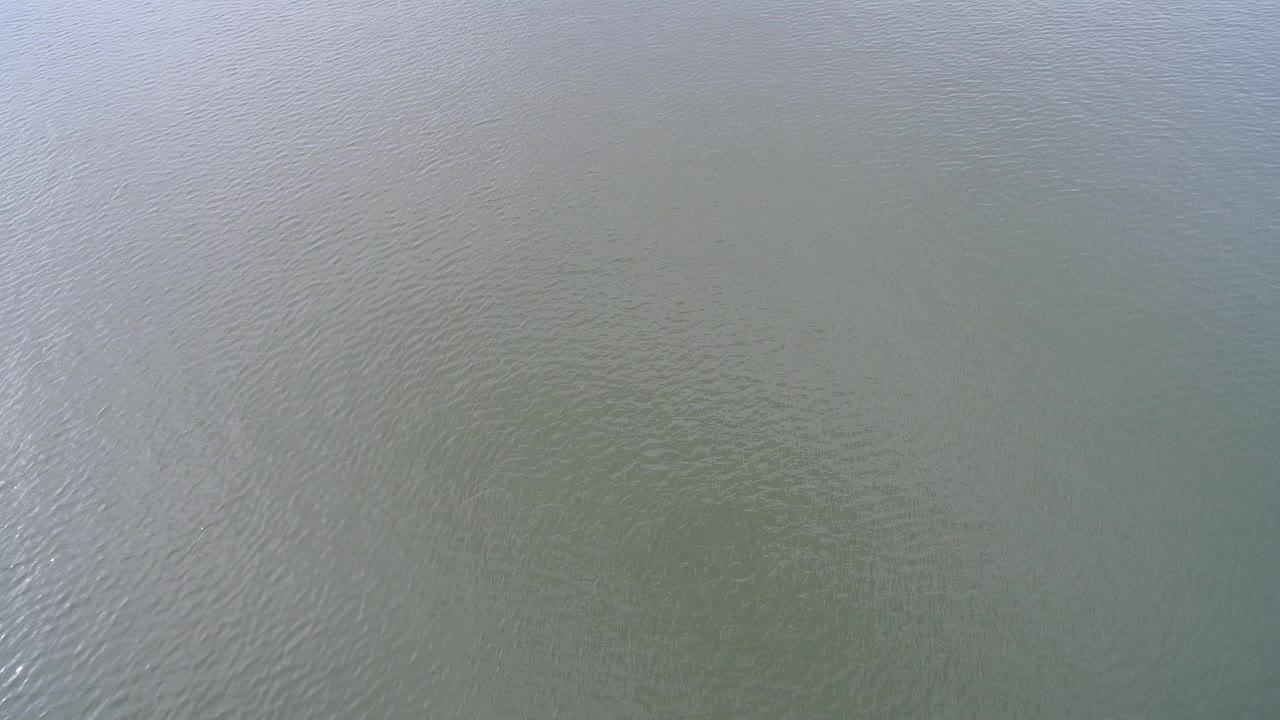 Aerial view of rippling pale green-blue water