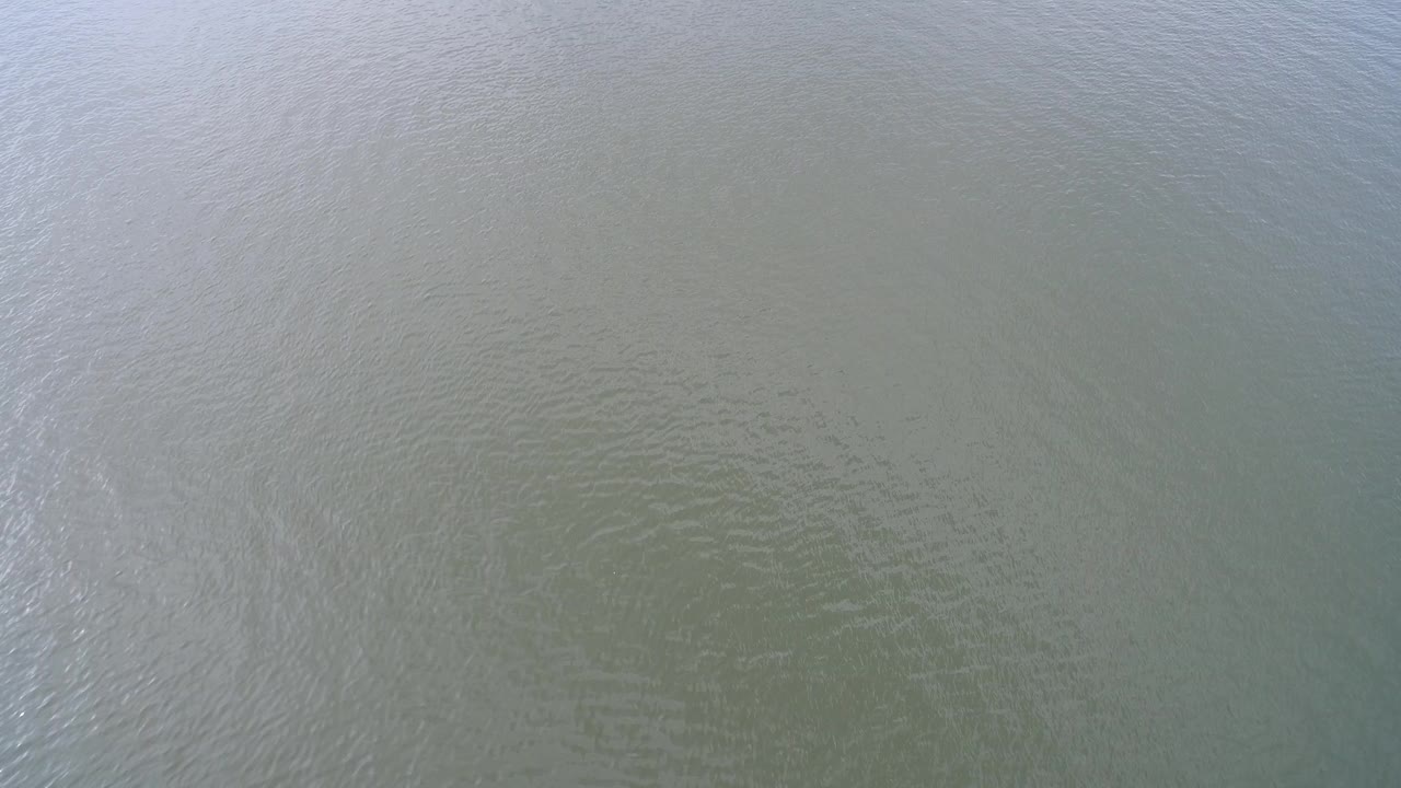 Overhead view of pale green Hidden Lake Colorado water with fine ripples and no visible people.