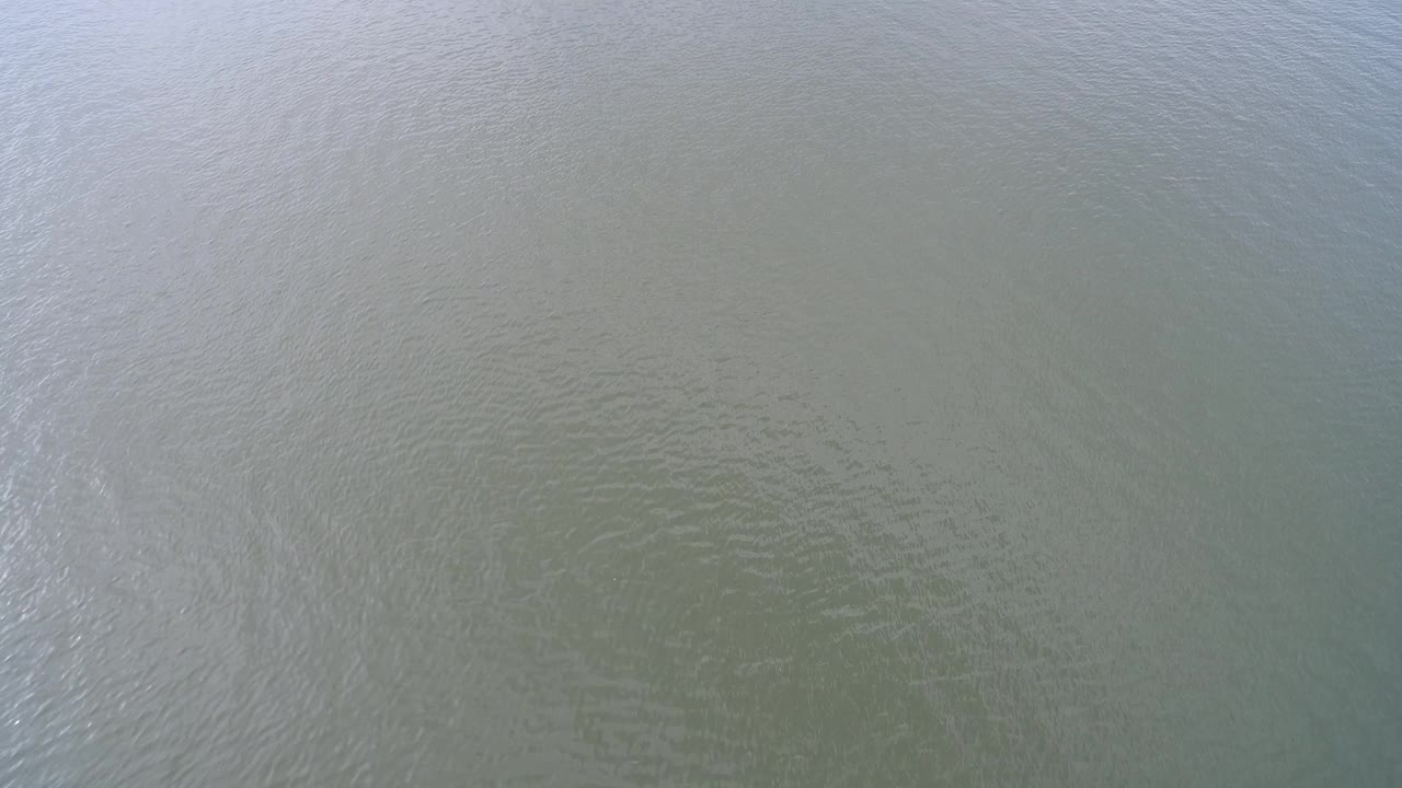 Aerial view of Hidden Lake Colorado water where a faint brighter vertical ripple pattern crosses the surface, with no visible people.