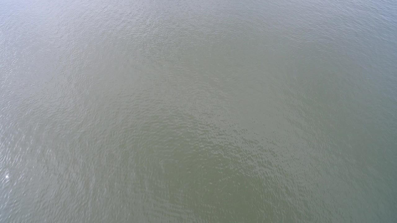 Overhead view of pale green Hidden Lake water with fine ripples and no visible people at the start of the clip.