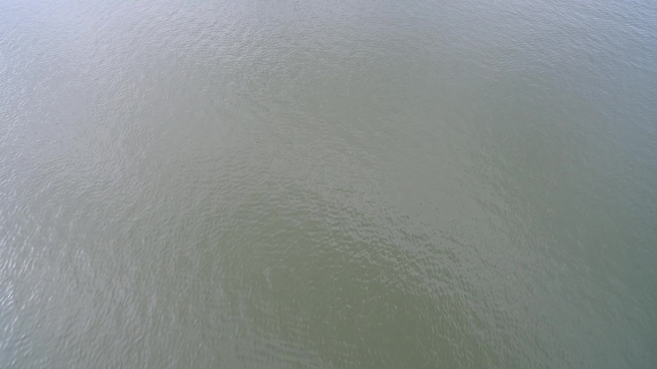 Blue-green Hidden Lake water fills the frame with subtle wave patterns and no visible people one second into the clip.
