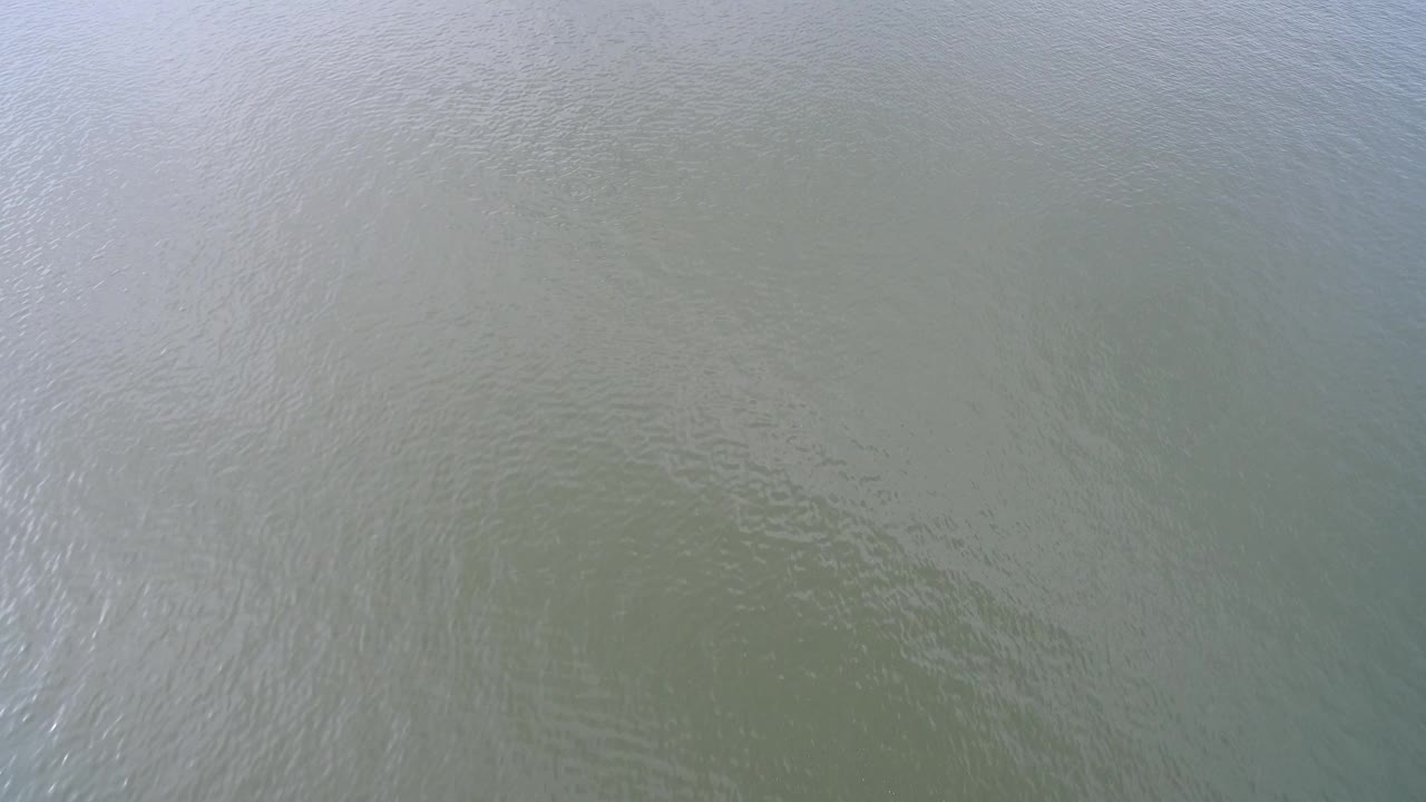 Muted lake surface with broad soft reflections