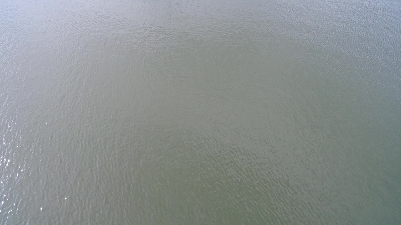 Aerial top view of Hidden Lake, Colorado water with a brighter vertical sun reflection through the center-left area and no visible people.
