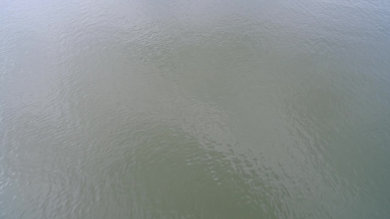 Soft ripples across reflective lake water.