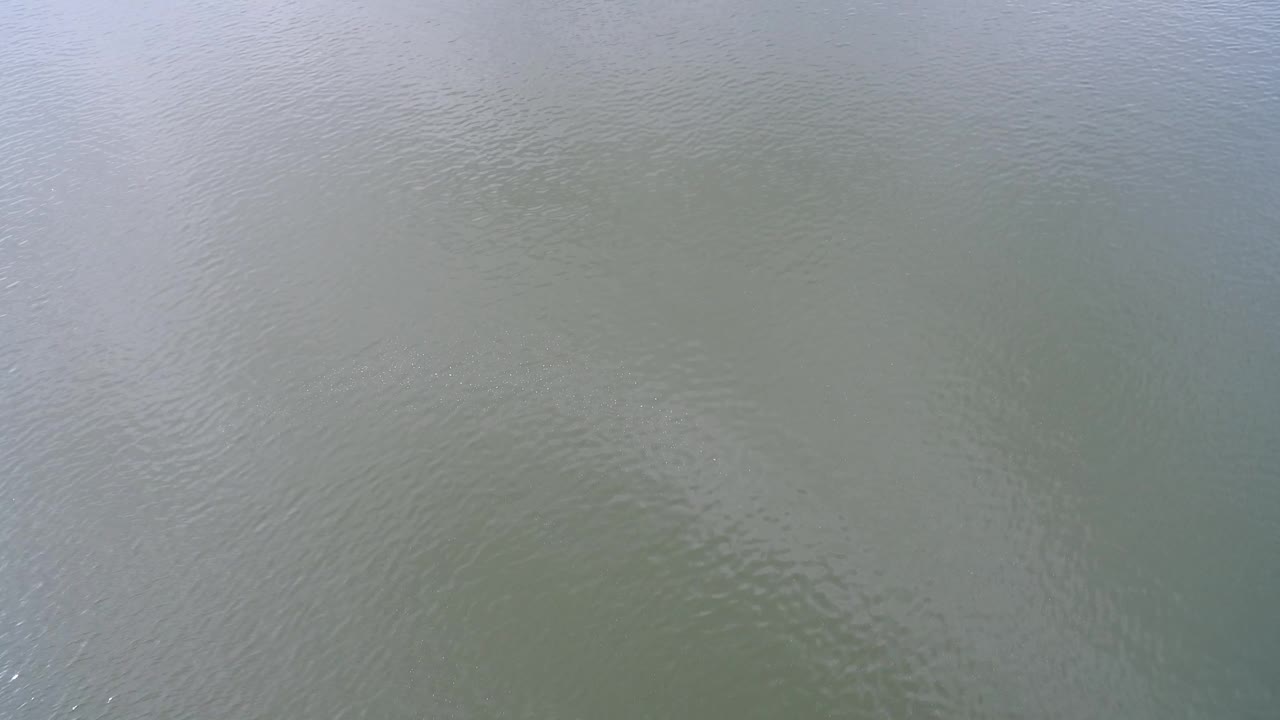 Close overhead view of muted lake water ripples