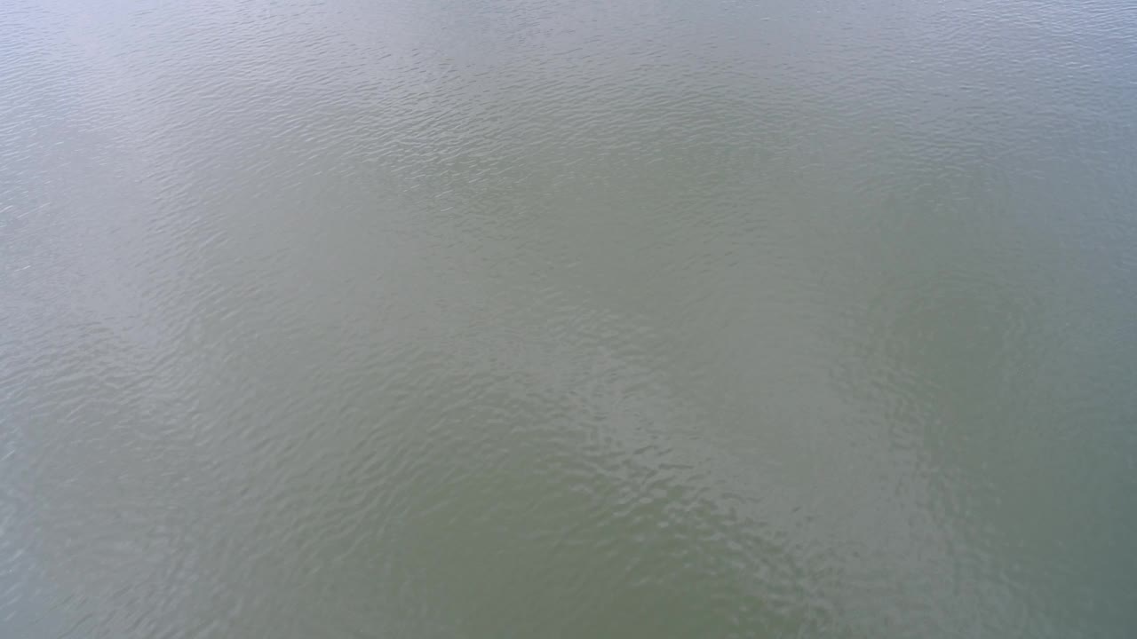 Close view of pale green-blue water at Hidden Lake, Colorado, with fine ripples and no visible people.
