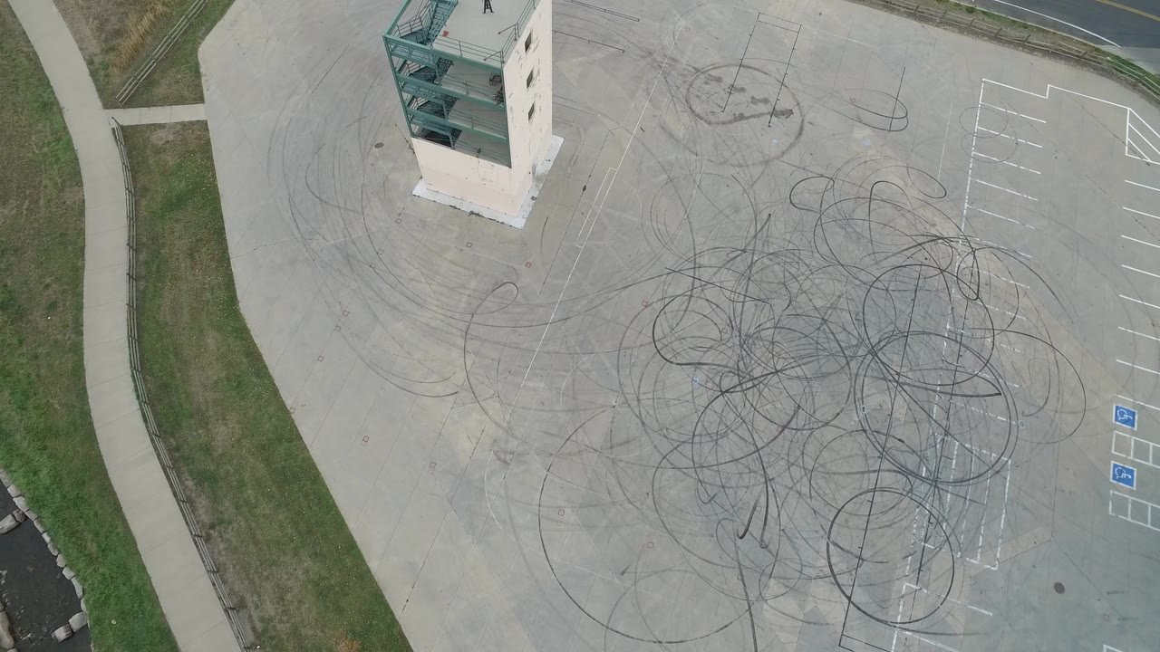 Top-down parking area with tire circles and accessible parking symbols.